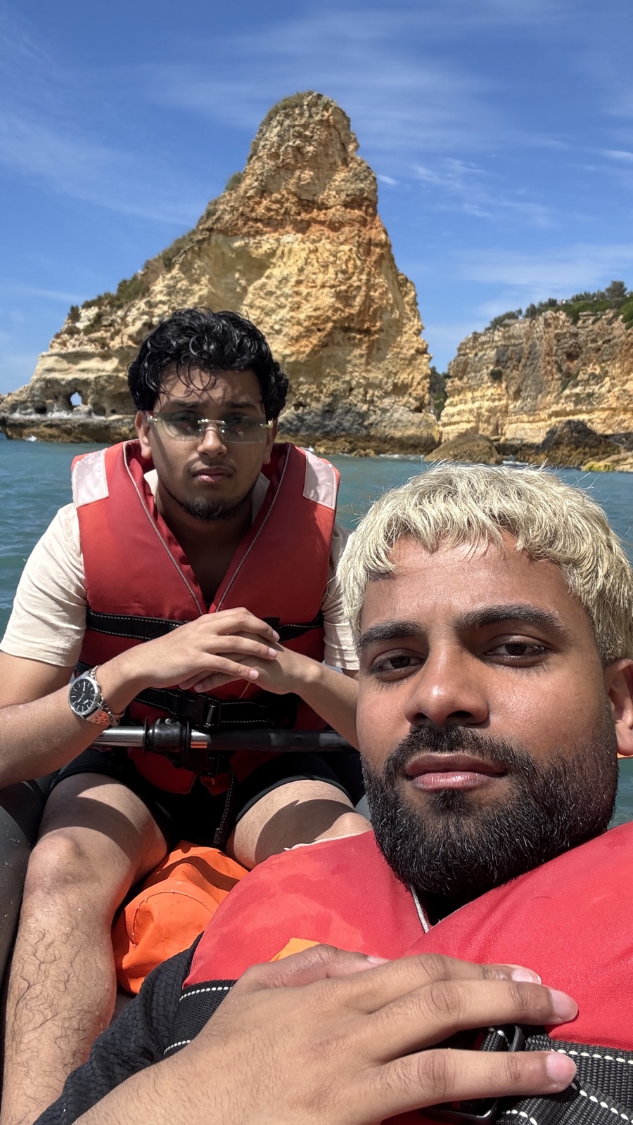 Kayaking beside golden coastal cliffs