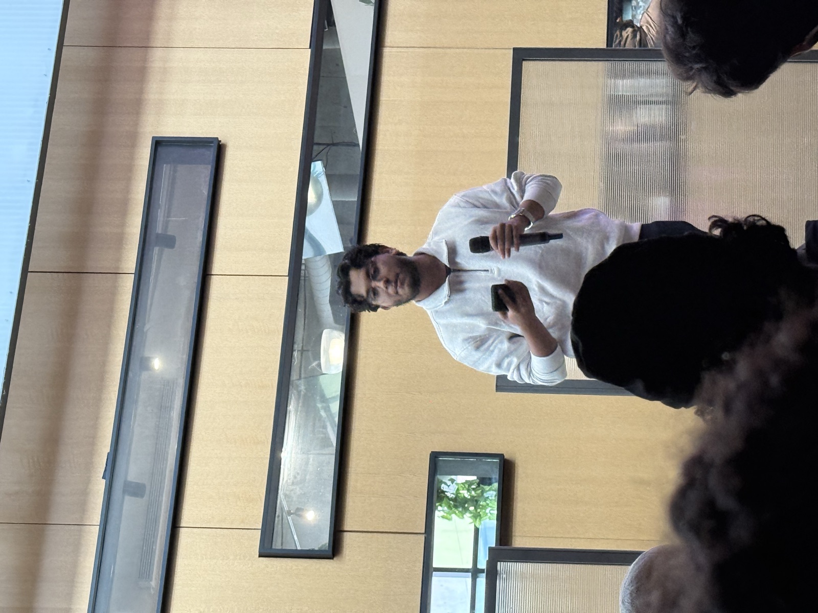 Fahmid speaking into a microphone at an event