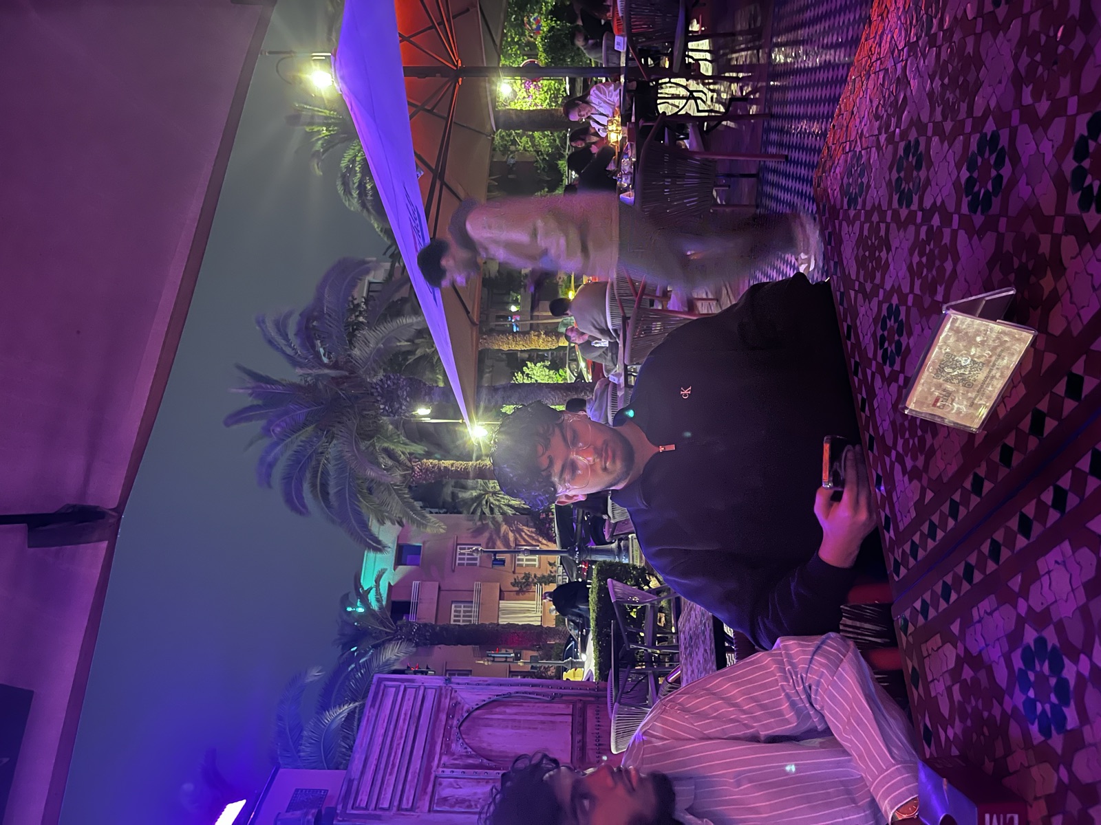 Fahmid at an outdoor restaurant in the evening